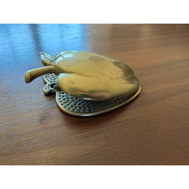 A charming vintage brass apple wall clip with a simple, sculptural form and warm patina. Both decorative and functional,...