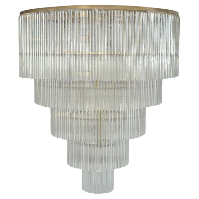 A monumental five-tier brass and glass chandelier attributed to Christoph Palme, created as a custom commission for a...