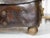 An antique English leather case from the 19th century, with GR crowned monogram, brass handles and petite ball feet....