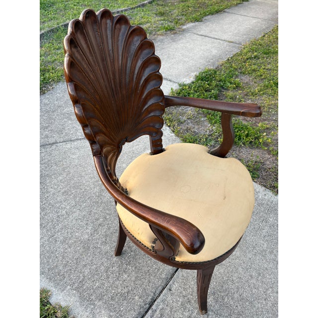 Mid-20th Century Italian Venetian-style grotto armchair, featuring a hand-carved shell-shaped backrest and a neutral beige...