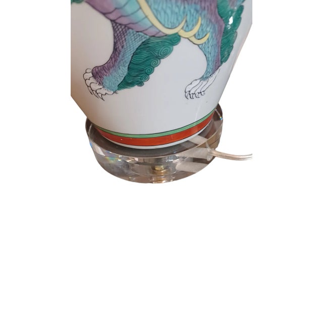 Vintage pair of ceramic vases with a handpainted Asian scene of warriors on horse and dragon back. Exquisite colors....