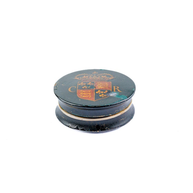 Round black lacquered/japanned box, flared foot, hand-painted lid with coronet over a quartered royal-arms-style shield...