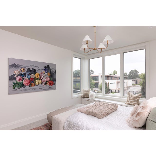 This artwork features a vibrant array of flowers bursting forth from a backdrop of grey mountains, creating a striking...