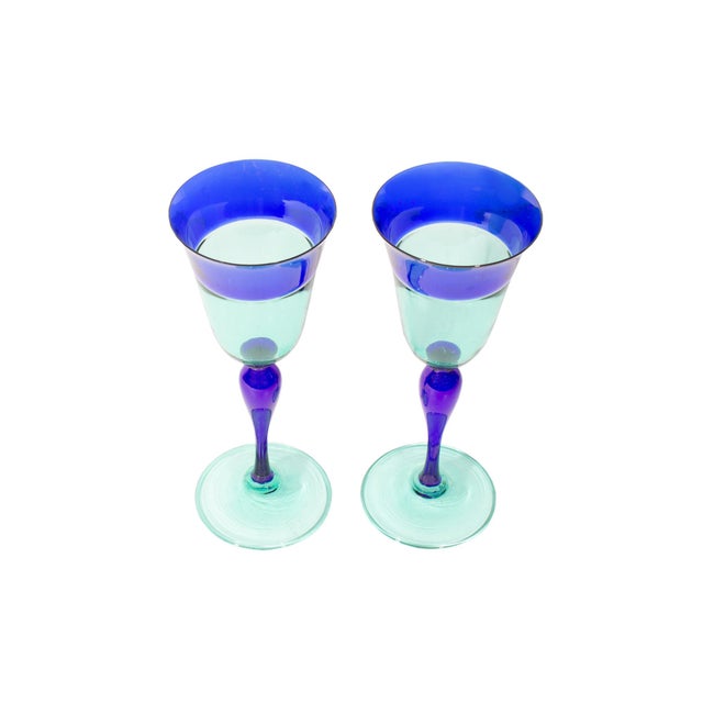 A pair of Murano glass goblets by the Italian glassmaker Davide Fuin. Made in Italy, these goblets features a blue rim and...