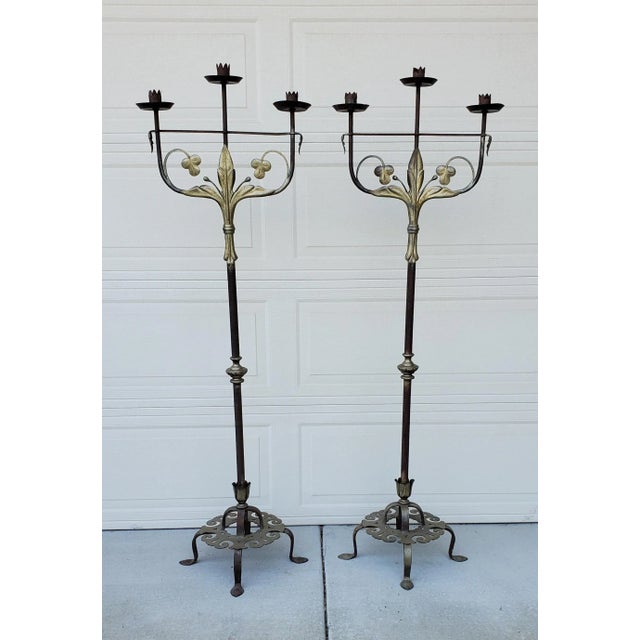 Pair of Hand hammered 20th Century Wrought iron floor candelabra torchieres with gold gilt metal leaf scrollwork and vine...