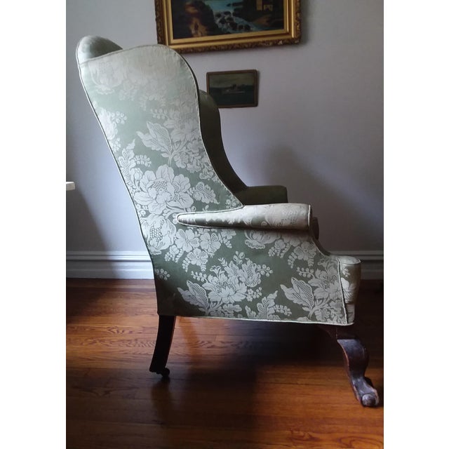 This Georgian period Armchair has unusually large proportions both in height and width. It is a wingback, with arms...
