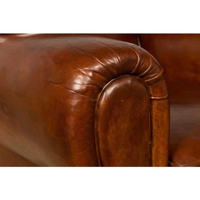 A striking pair of French Art Deco club chairs sourced in Provence, France, dating to the 1940s. Upholstered in richly...