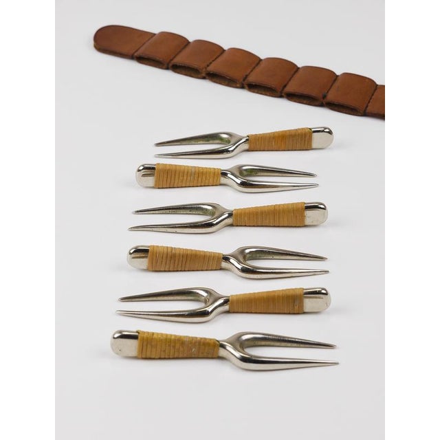 A set of six small forks with a leather holster, model no. 3679, designed by Carl Auböck and executed by Werkstätte Carl...