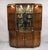 Drexel Heritage Modern Campaign Style 3 Piece Lighted China Cabinet Curio Display. Circa Late 20th Century. Measurements:...