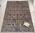 A hand-knotted area rug in the Sultanabad design, woven in Afghanistan on a warm taupe-grey ground and drawn with rows of...