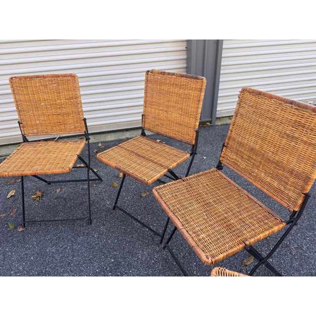 Vintage rattan French cafe dining set. Table and chairs are in very solid condition. Several broken reeds but does not...