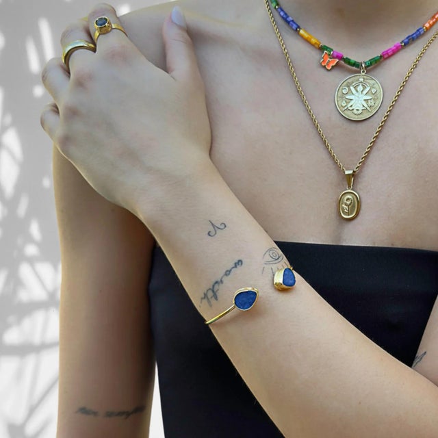 Cleopatra Blue Druzy Agate Gold Cuff Bracelet is a regal and enchanting accessory inspired by the legendary queen herself....