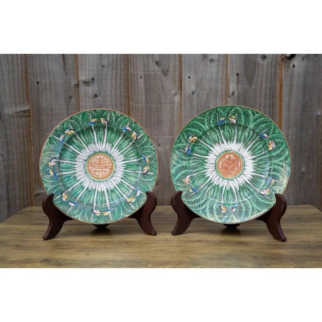 A charming pair of antique Chinese porcelain plates dating to the late Qing dynasty, circa 1850–1899, beautifully...