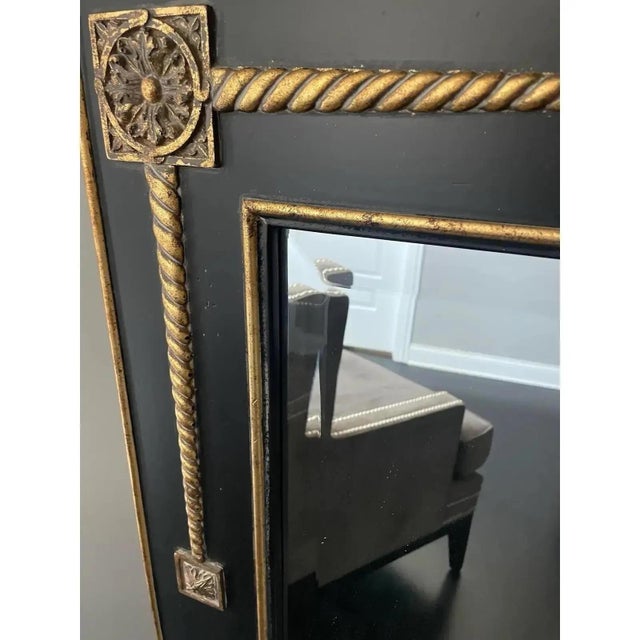 Offered is a striking statement wall mirror. This mirror features beveled glass, solid wood black frame with gold accents....