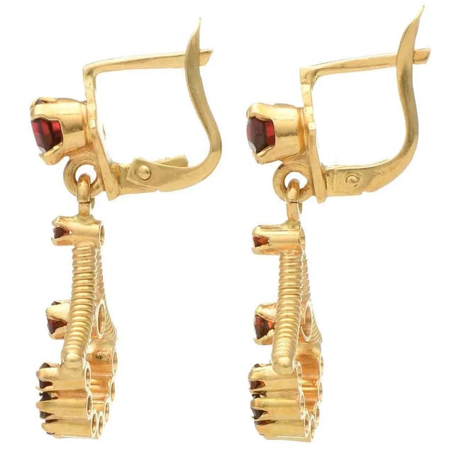 These beautiful earrings feature vivid pyrope garnets in a deep red color that evokes enduring affection. Their classic...