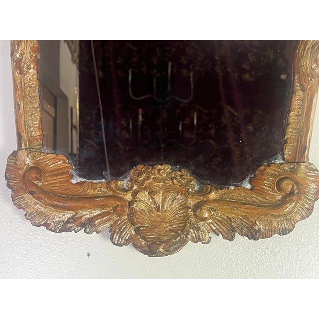 19th C. Italian mirror with a highly ornate and elaborate frame, characteristic of the Rococo style. The frame is gilded...