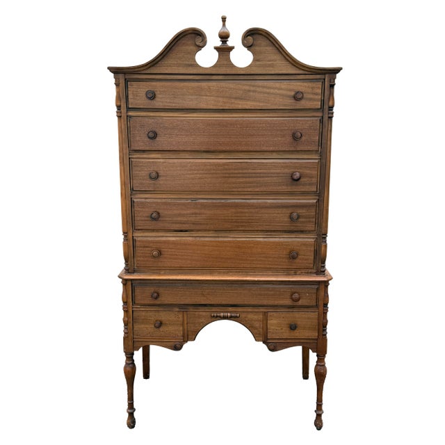 Beautiful antique highboy from the 1920's. Original finish. Pediment top with turned front legs. 8 drawers that all are...