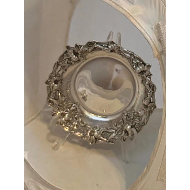 This vintage small sterling silver bowl is beautifully designed with an elaborate sculpted floral motif. It is decorated...