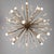 A 20 light Modernist Sputnik chandelier. Patinated brass with brass rods extending out from the center in all directions....