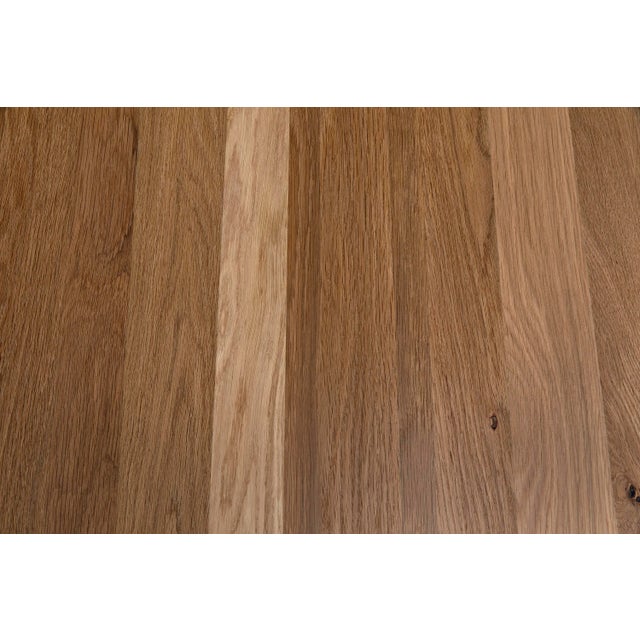 The Kirill Table in White Oak is a captivating piece of furniture that exudes elegance and sophistication, making it an...