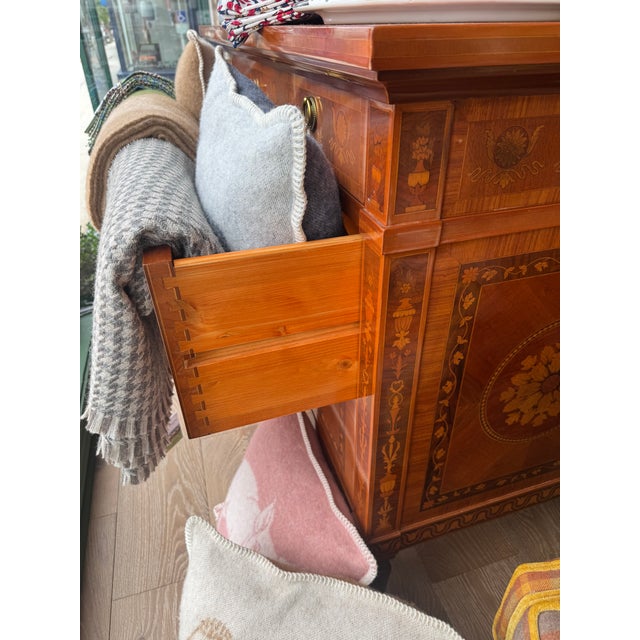 Bring old-world warmth and decorative craftsmanship into your space with this Vintage Marquetry Walnut Commode, likely a...
