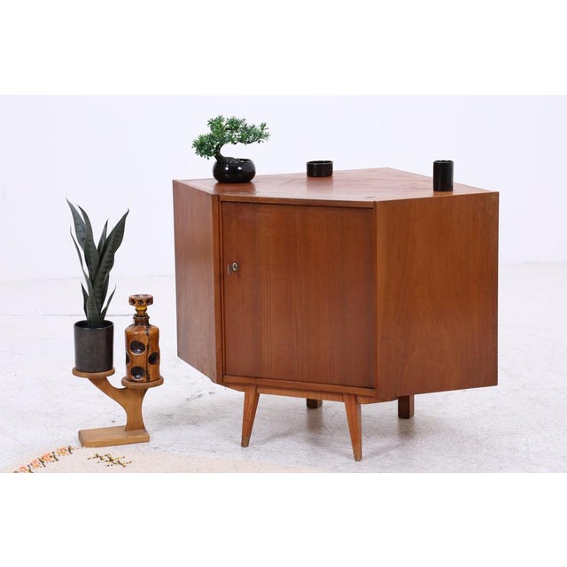 Vintage corner chest of drawers from the 1960s. Its unique shape makes optimal use of room corners and offers practical...