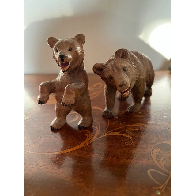 A two piece grouping of black forest style hand carved bear figures with painted faces and paws! One standing and one...