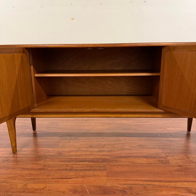 Vintage mid-century long teak sideboard by Herbert Gibbs for A. Younger Ltd. circa 1970's. This is a high-quality piece...