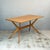 A redford dining table by e. Gomme, known as the 'helicopter' for its unusual base. At each end, four shaped limbs radiate...