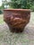 A striking vintage Chinese ceramic planter with a dramatic raised dragon motif in rich brown glaze. The dragon, a symbol...