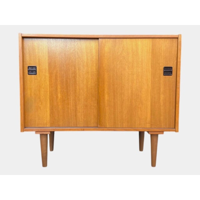 This exceptional Danish Modern cabinet beautifully embodies the clean lines, understated elegance, and functional...
