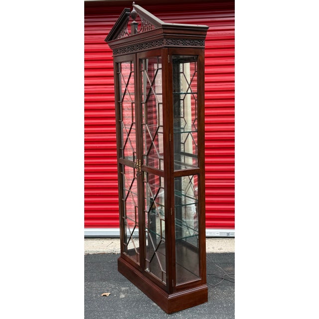 Gorgeous Chippendale style curio cabinet by Stickley furniture. Impeccably crafted from solid mahogany the cabinet...