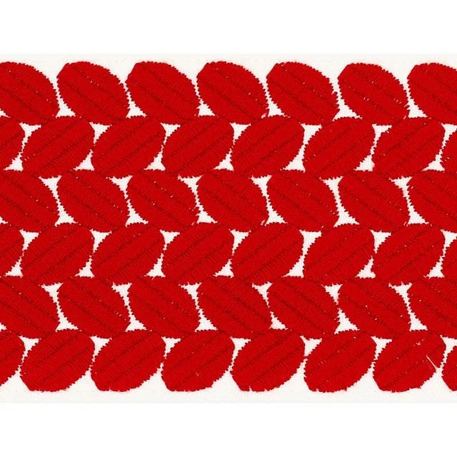 An exuberant embroidered tape with a leaf-like pattern rendered in satin stitching; inspired by a document in our...