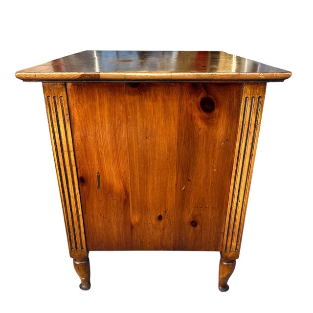 Signed "Pine-tique of Muskegon, Mich.," this small chest or dresser could serve as an end table or nightstand. The warm...