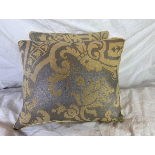 These Fortuny pillows feature an opulent and historically inspired textile design, richly printed in antique gold over a...