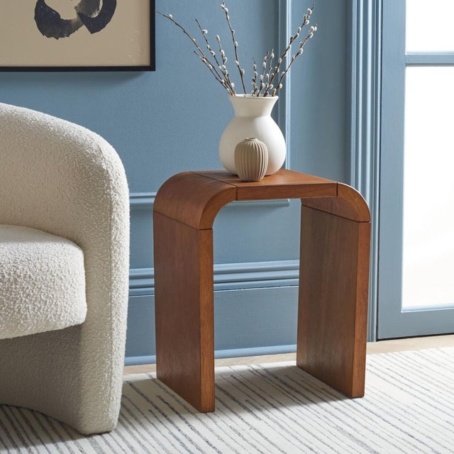 Introducing the LiaSonya curved accent table in natural, a perfect blend of elegance and functionality for your living...