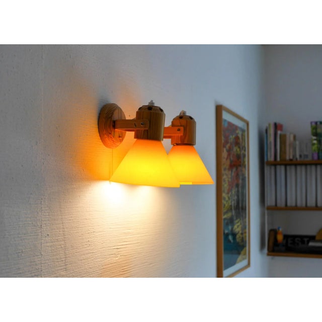 A pair of modern scandinavian vintage pine sconces/ wall lighing, which have a orange acrylic cone. The lamps are from to...