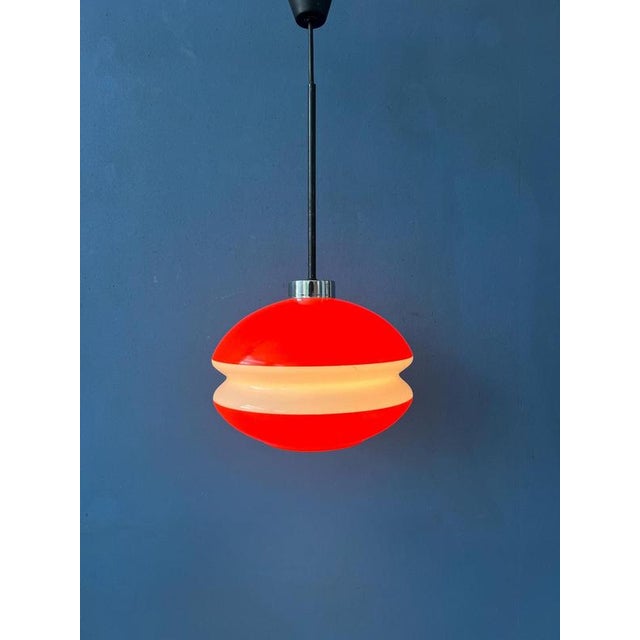 Beautiful orange Peill and Putzler glass pendant lamp. The combination of the orange and white glass gives the piece its...
