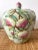 Large size chinoiserie green ginger jar adorned with fruit, flowers, and birds in pinks, greens, and blues. Signed on...