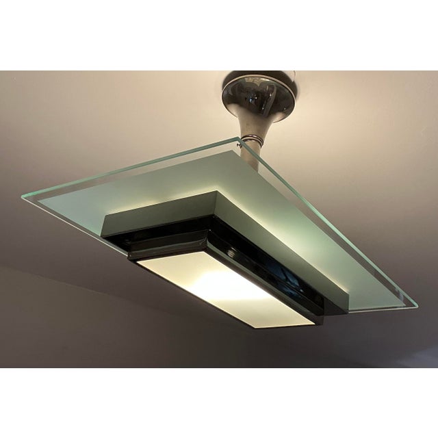 This rectangular Art Deco chandelier from Petitot is made of nickel-plated brass and features a partially etched glass...