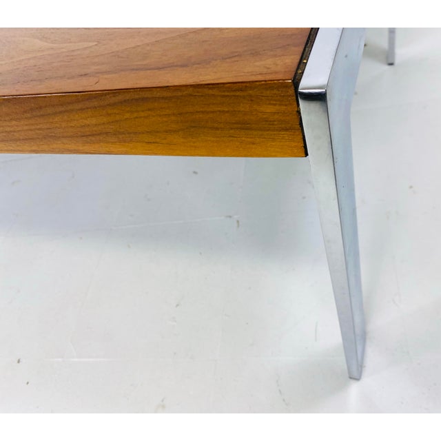 This is a mid-century vintage dark walnut and chrome coffee table after Milo Bowman. This coffee table has modern chrome...