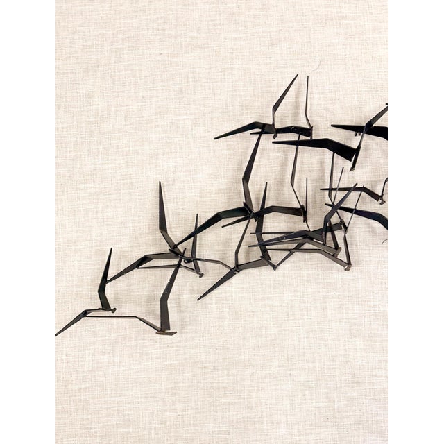 This striking vintage iron flock of birds wall sculpture is a bold and dramatic large scale wall art find. The sweeping...