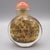 A beautifully crafted vintage snuff bottle featuring intricate eglomise, reverse hand-painted depictions of featuring a...