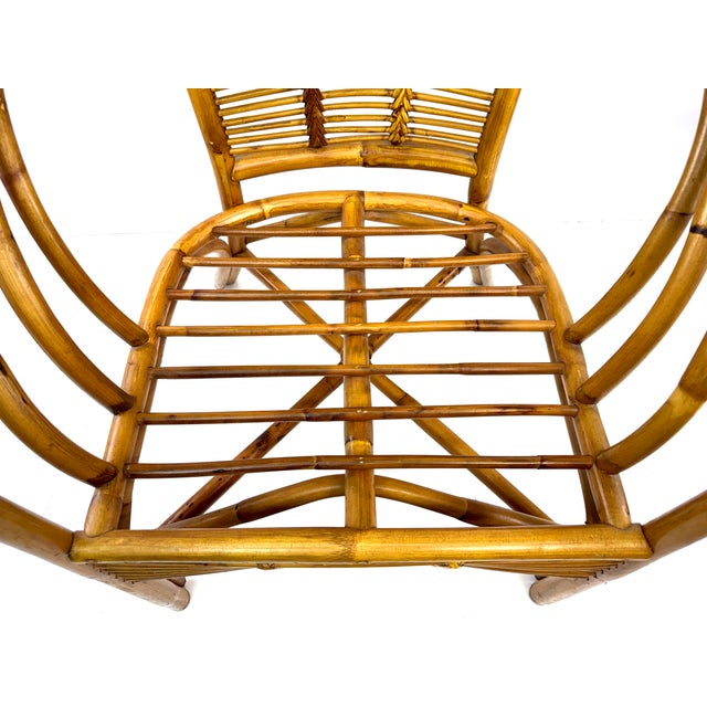 Graceful curves and airy craftsmanship define this vintage bent bamboo lounge chair, designed with a sweeping wraparound...
