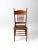 This is an antique press back side chair circa late 19th century. The tall back wooden chair features a "press" back top...