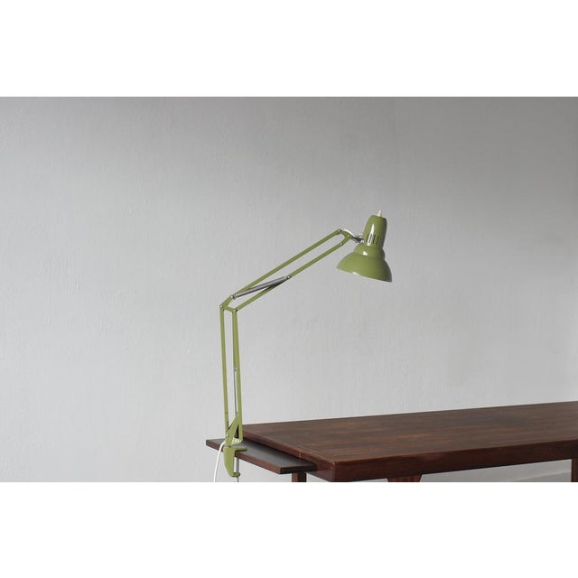 Minimalist form meets maximum functionality. The classic Swedish Ledu desk lamp in a deep olive shade is a nod to timeless...