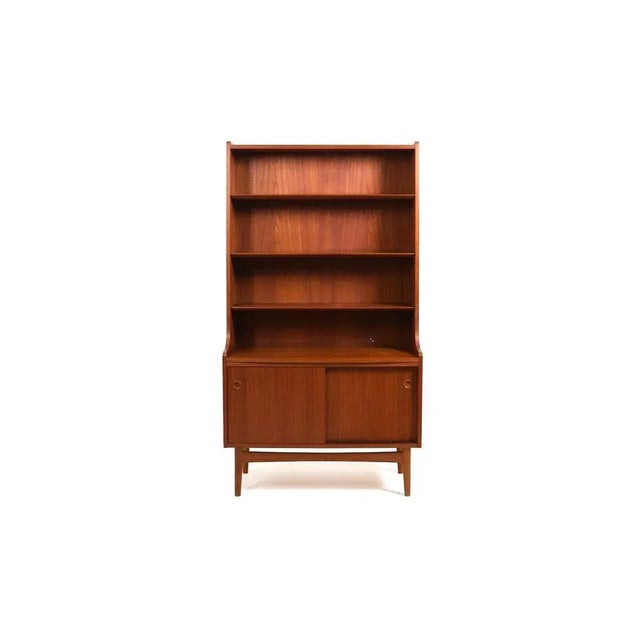 Cabinet / bookshelf / book case in teak by johannes sorth for nexø møbelfabrik bornholm. Conical shape with shelves and...