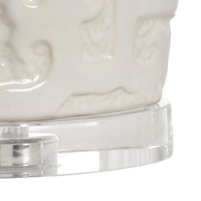 Cream glaze on oval asian raised design. Clear crystal mounting. 30.5h x 7.5w x 5d Shade Dimensions: top(10 x 18.5)...