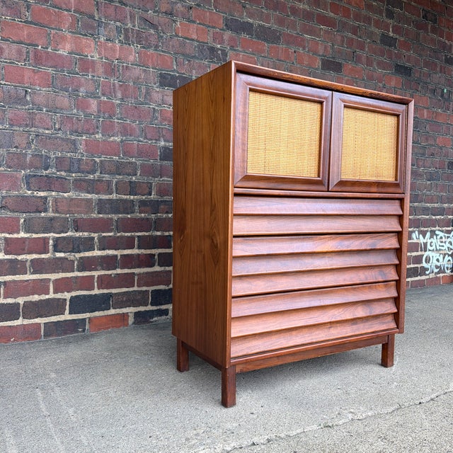 A striking Mid-Century Modern tall chest from the highly desirable Wonderwood collection by American of Martinsville....