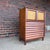 A striking Mid-Century Modern tall chest from the highly desirable Wonderwood collection by American of Martinsville....